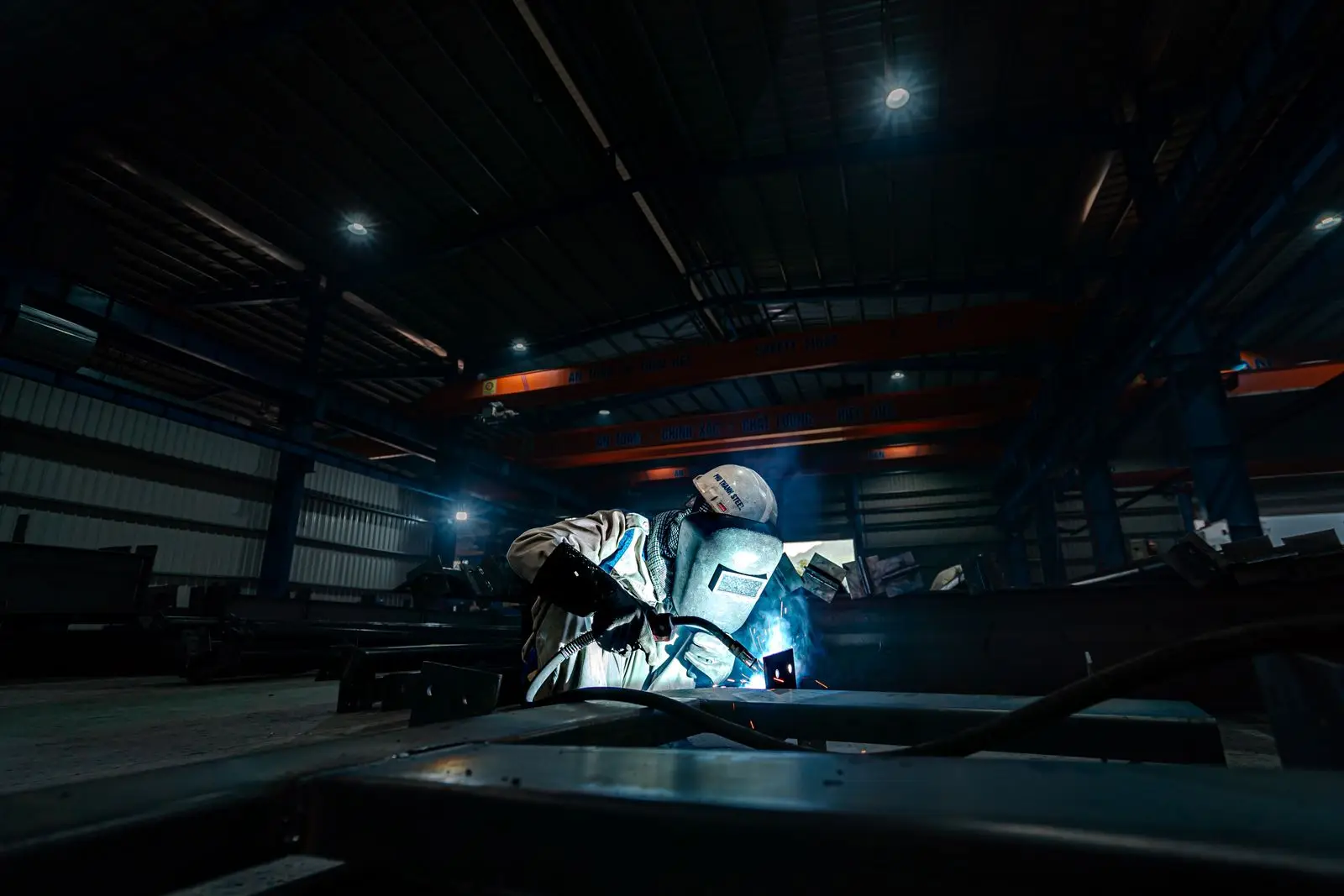 Technician working in a dim shop bay